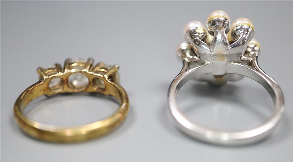 A modern 18ct white gold and cultured pearl cluster ring and a paste three stone ring